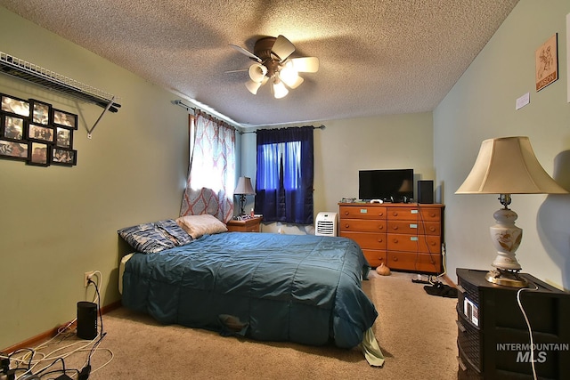 carpeted bedroom with ceiling fan and a textured ceiling