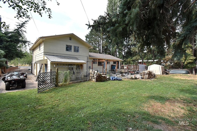 back of house with a lawn