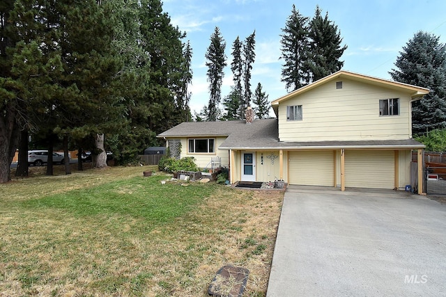 split level home with a garage and a front yard