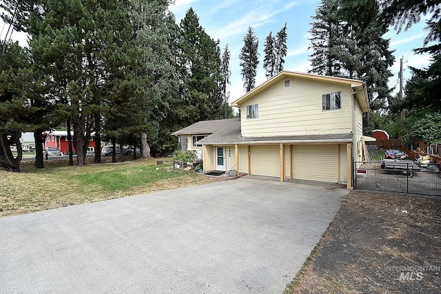 view of front of property featuring a garage and a front lawn