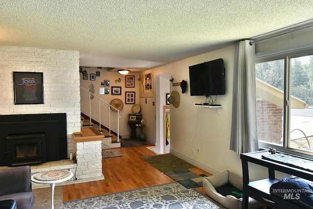 living room featuring hardwood / wood-style floors and a textured ceiling