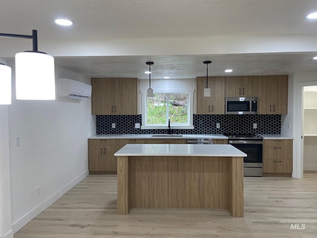 kitchen featuring a wall unit AC, light wood-style flooring, stainless steel appliances, light countertops, and a sink