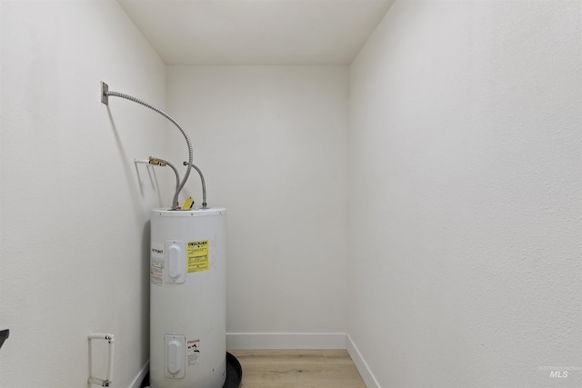 utility room with electric water heater