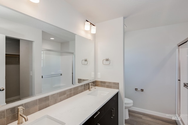 full bathroom with a shower stall, tasteful backsplash, and a sink