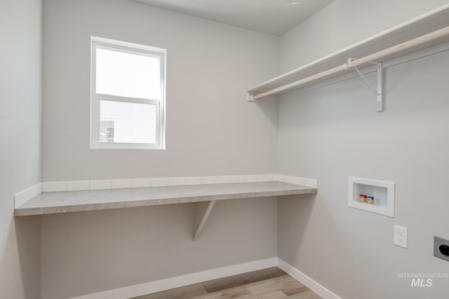 washroom with laundry area, baseboards, wood finished floors, hookup for a washing machine, and electric dryer hookup