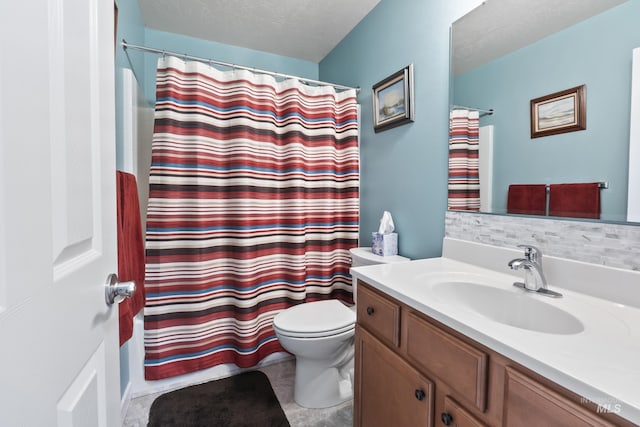 bathroom with toilet, vanity, a textured ceiling, and tasteful backsplash