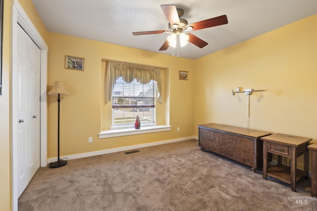 misc room featuring ceiling fan and light carpet