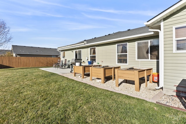 rear view of house featuring a yard and a patio area