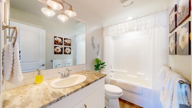 full bathroom with shower / bathtub combination with curtain, toilet, and vanity