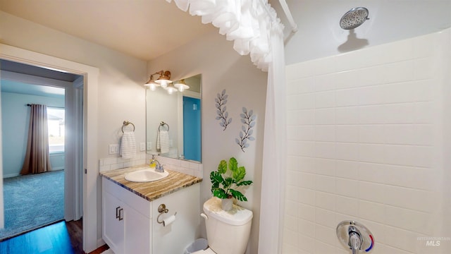 full bathroom with toilet, backsplash, wood finished floors, a shower with shower curtain, and vanity