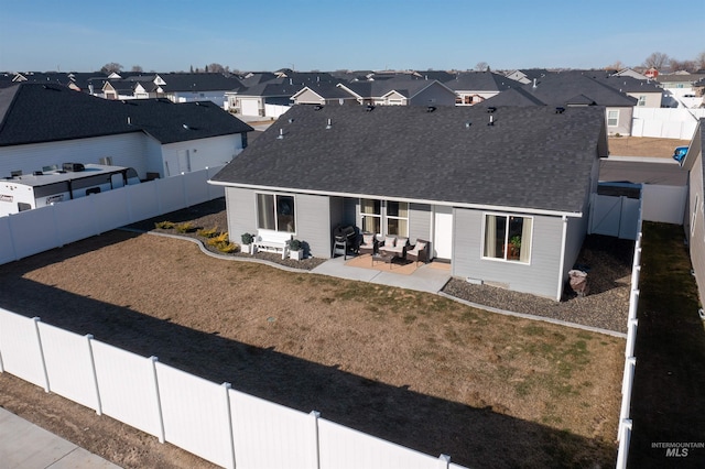 rear view of house with a residential view, roof with shingles, a patio, and a fenced backyard