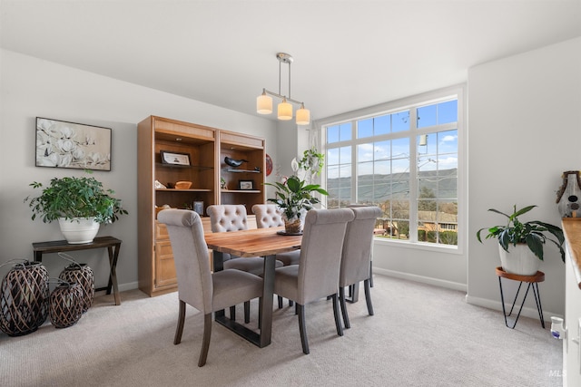 carpeted dining room with a mountain view