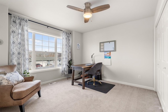 carpeted home office with ceiling fan