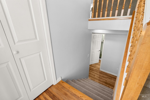 stairs with hardwood / wood-style flooring