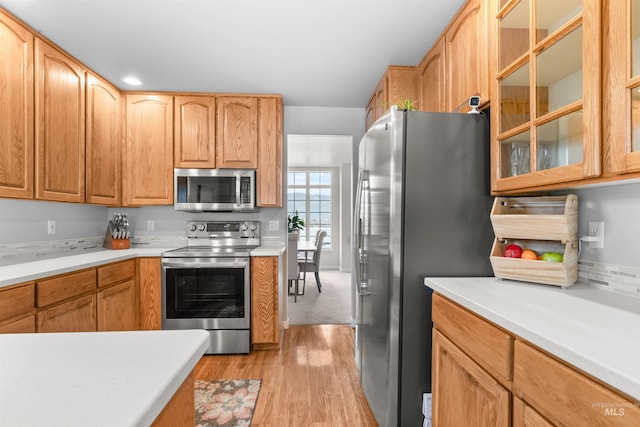 kitchen featuring light wood-type flooring and appliances with stainless steel finishes