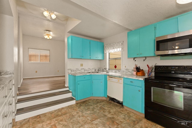 kitchen featuring black range with electric stovetop, stainless steel microwave, white dishwasher, and plenty of natural light