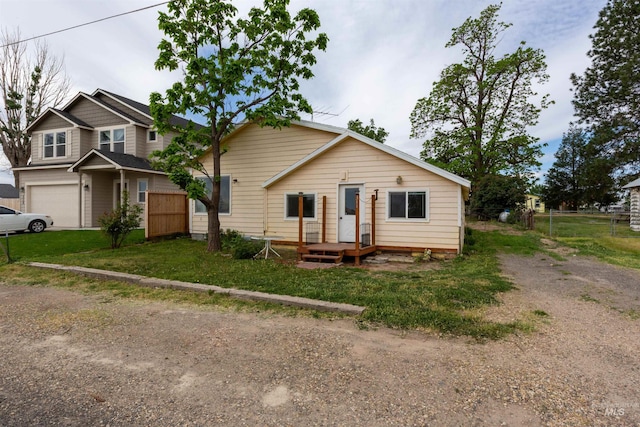 view of front of property with dirt driveway and a garage