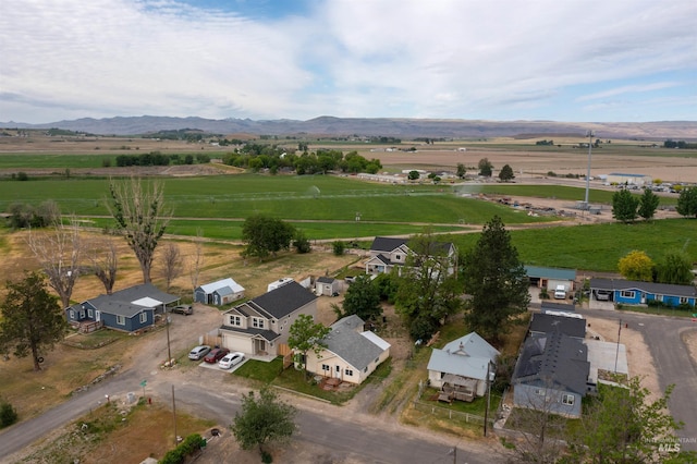 aerial overview of property's location featuring rural landscape and a mountainous background