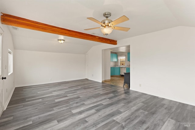 spare room with wood finished floors, ceiling fan, and baseboards