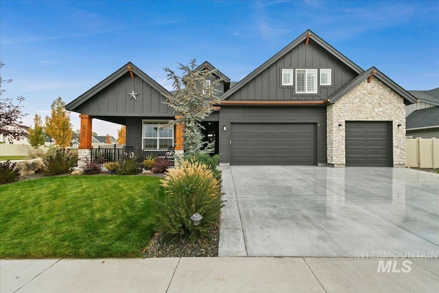 view of front of home featuring a front yard, a garage, and a porch