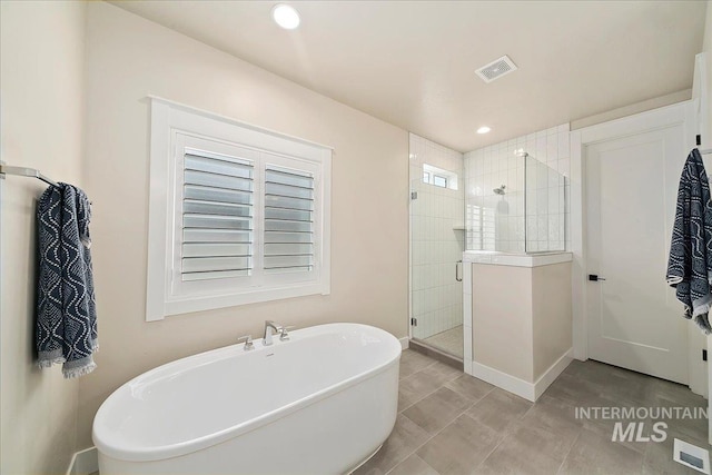 bathroom with tile patterned floors and plus walk in shower