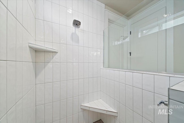 bathroom with tiled shower