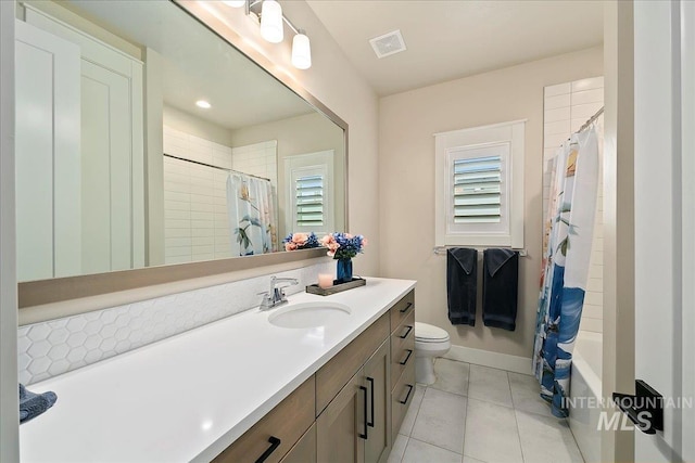 bathroom with tile patterned flooring, vanity, and toilet