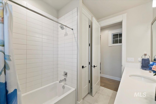 bathroom with shower / bathtub combination with curtain, tile patterned floors, and vanity