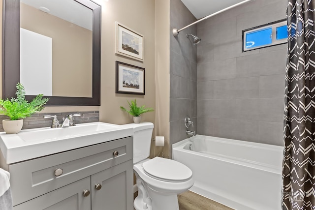 bathroom with toilet, vanity, and shower / bath combo