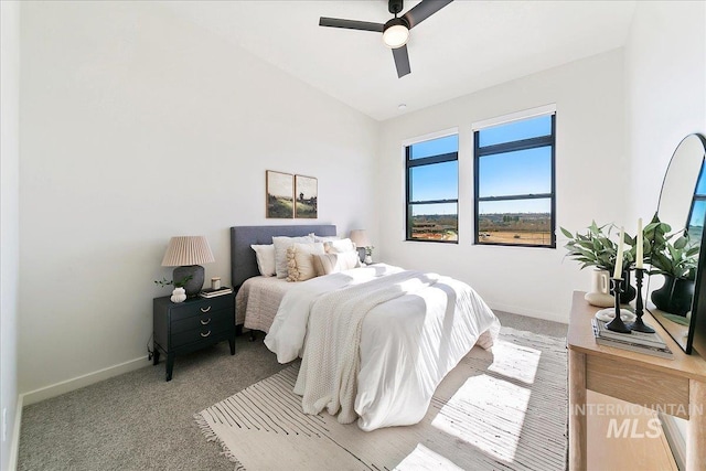 bedroom with baseboards, carpet flooring, and vaulted ceiling