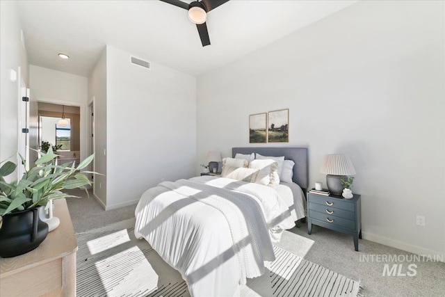 carpeted bedroom featuring visible vents, baseboards, and a ceiling fan