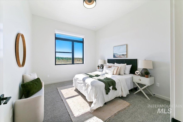 carpeted bedroom featuring baseboards