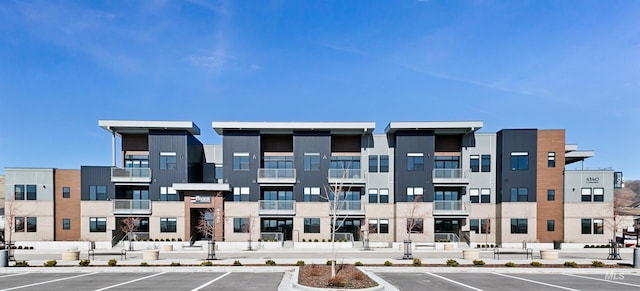 view of building exterior featuring uncovered parking