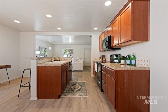 201 W Lava Fls, Meridian, ID 83646 - kitchen with electric range, a sink, light wood finished floors, brown cabinets, and recessed lighting