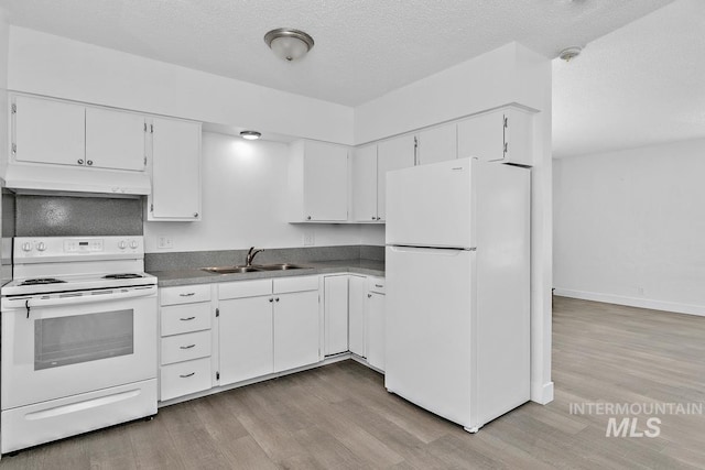 135 Davis Ave, Nampa, ID 83651 - kitchen with white appliances, under cabinet range hood, a sink, light wood-style floors, and a textured ceiling