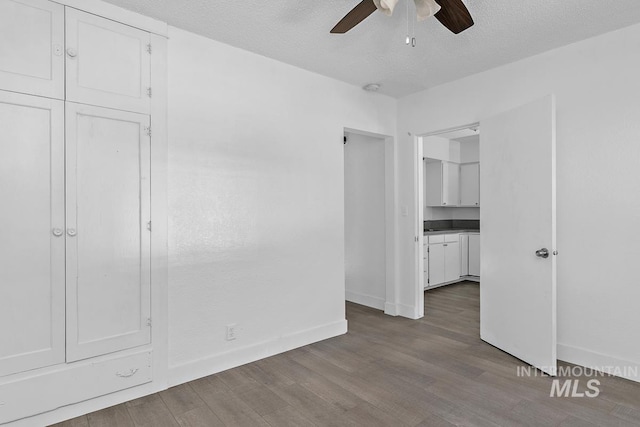 135 Davis Ave, Nampa, ID 83651 - unfurnished bedroom with wood finished floors, baseboards, a textured ceiling, and ceiling fan