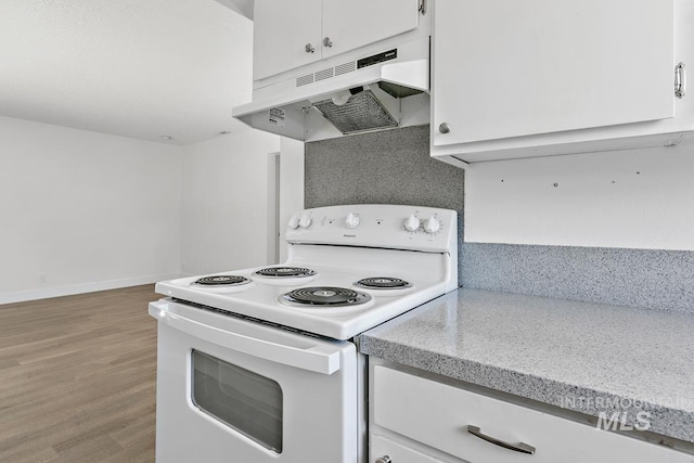 135 Davis Ave, Nampa, ID 83651 - kitchen with white electric range, under cabinet range hood, white cabinetry, and light wood-style flooring