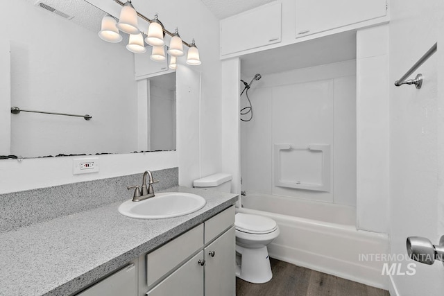 135 Davis Ave, Nampa, ID 83651 - full bathroom with vanity, wood finished floors, toilet, and shower / tub combination