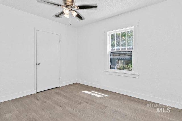 135 Davis Ave, Nampa, ID 83651 - unfurnished room with wood finished floors, a ceiling fan, baseboards, and a textured ceiling