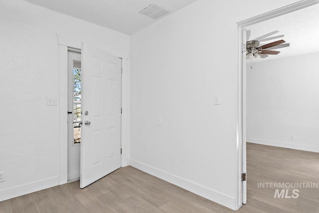 135 Davis Ave, Nampa, ID 83651 - foyer with light wood-type flooring, a ceiling fan, baseboards, and a textured ceiling