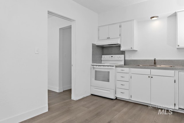 135 Davis Ave, Nampa, ID 83651 - kitchen with white electric stove, under cabinet range hood, light wood-type flooring, a sink, and white cabinets