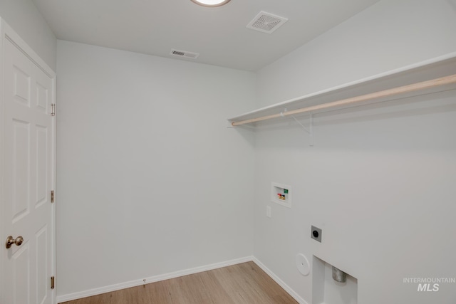 clothes washing area with washer hookup, gas dryer hookup, electric dryer hookup, and light hardwood / wood-style floors