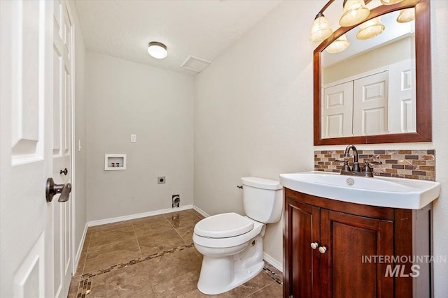 bathroom with tile patterned floors, decorative backsplash, toilet, vanity, and a textured ceiling