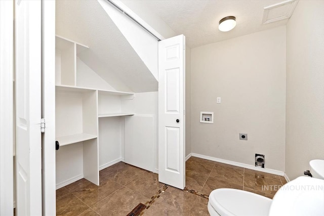 bathroom with toilet, a textured ceiling, and tile patterned floors