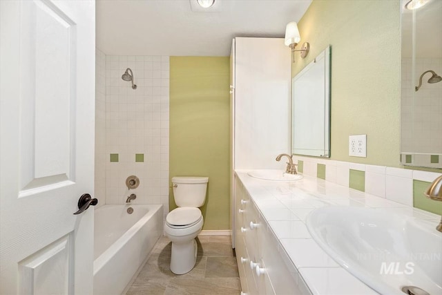 full bathroom with backsplash, toilet, tile patterned floors, vanity, and tiled shower / bath combo