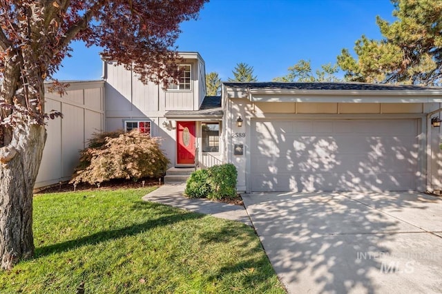 view of front facade with a front yard and a garage