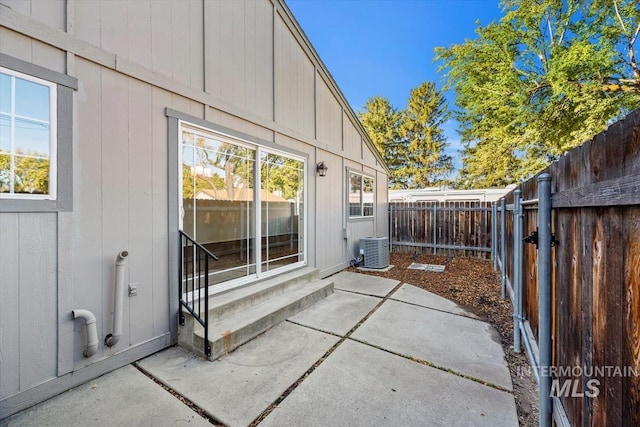 view of home's exterior with a patio and central AC unit