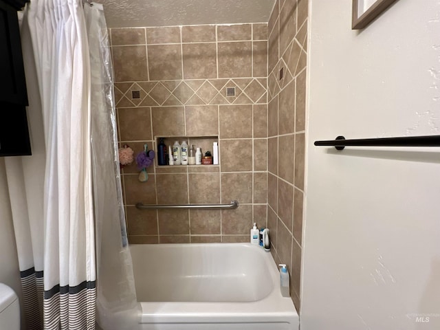 full bath with toilet, shower / bathtub combination with curtain, and a textured ceiling