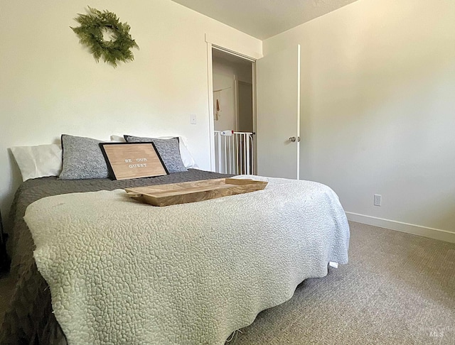 bedroom with carpet floors and baseboards