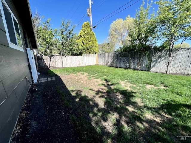 view of yard with a fenced backyard